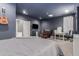 Spacious, carpeted main bedroom featuring a queen-size bed, a desk, and a mounted flat screen TV at 1917 S Rock Ct, Gilbert, AZ 85295