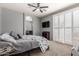 Main bedroom featuring neutral walls and carpet, fan, shutters, and view of the ensuite bath at 1917 S Rock Ct, Gilbert, AZ 85295