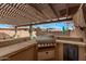 Built-in outdoor kitchen under a stylish pergola, perfect for alfresco dining and entertaining guests by the pool at 1917 S Rock Ct, Gilbert, AZ 85295