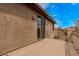 A private outdoor patio with tan walls and a blue sky view is accessible via sliding glass doors at 1917 S Rock Ct, Gilbert, AZ 85295
