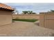 View of the backyard showcasing artificial grass and pavers at 20997 N 96Th Ln, Peoria, AZ 85382