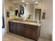 Bathroom with double sink vanity, granite countertop, and large mirrors at 20997 N 96Th Ln, Peoria, AZ 85382