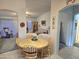 An open-concept dining area showcases a light wood table with seating for six at 2101 S Meridian Rd # 354, Apache Junction, AZ 85120