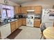 Well-lit kitchen features natural wood cabinets and includes essential appliances for cooking at 2101 S Meridian Rd # 354, Apache Junction, AZ 85120