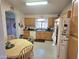 Functional kitchen featuring classic cabinets, a bright dining area, and essential appliances at 2101 S Meridian Rd # 354, Apache Junction, AZ 85120