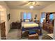 Cozy main bedroom features wood furniture, ceiling fan, and soft, inviting light at 2101 S Meridian Rd # 354, Apache Junction, AZ 85120