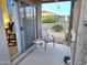 Covered patio with a table, chairs and a view of another house from sliding glass door at 2101 S Meridian Rd # 354, Apache Junction, AZ 85120