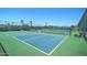 Community pickleball courts with well-maintained green and blue surface, benches, and surrounding landscaping at 2101 S Meridian Rd # 354, Apache Junction, AZ 85120