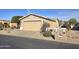 A neat single-story house features a two-car garage and desert landscaping at 2101 S Meridian Rd # 354, Apache Junction, AZ 85120