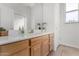 Bathroom showing a wood vanity, neutral paint, and a mirror at 2109 N Nancy Ln, Casa Grande, AZ 85122