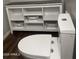 Bathroom featuring a toilet and a white storage shelf with decorative baskets at 21805 W Sonora St, Buckeye, AZ 85326