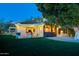 Beautiful backyard featuring a brick patio, lush green lawn and mature shade tree, perfect for outdoor living and entertaining at 2260 E Palmaire Ave, Phoenix, AZ 85020
