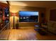 Living room with hardwood floors, a window view of the city lights, and an adjacent wet bar at 2260 E Palmaire Ave, Phoenix, AZ 85020
