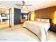 Large main bedroom featuring carpet, a ceiling fan, soft lighting, and backyard access at 2260 E Palmaire Ave, Phoenix, AZ 85020