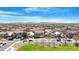 An aerial view captures the layout of homes in the community with its mature trees and beautiful Arizona landscape at 22959 W Cocopah St, Buckeye, AZ 85326