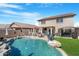 A sparkling swimming pool with a tanning deck, a covered patio and a landscaped backyard provide backyard entertainment at 22959 W Cocopah St, Buckeye, AZ 85326