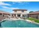 A spacious backyard with a swimming pool, tanning deck and a covered patio is perfect for outdoor entertaining at 22959 W Cocopah St, Buckeye, AZ 85326
