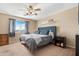 Cozy bedroom with a large window, soft carpeting, and a comfortable bed at 22959 W Cocopah St, Buckeye, AZ 85326