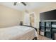 A simple bedroom with a ceiling fan, a view into the stairway, and a shelf for decor or storage at 22959 W Cocopah St, Buckeye, AZ 85326