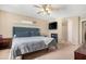 Spacious bedroom with plush carpet, ceiling fan, and soft, neutral color palette at 22959 W Cocopah St, Buckeye, AZ 85326