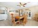 Bright dining room featuring a wooden table with seating for eight, complemented by a white china cabinet at 22959 W Cocopah St, Buckeye, AZ 85326