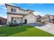 Two-story home with a well-maintained lawn, desert landscaping and a two car garage at 22959 W Cocopah St, Buckeye, AZ 85326
