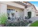 Charming front porch with rocking chairs and decorative plants, inviting curb appeal at 22959 W Cocopah St, Buckeye, AZ 85326