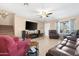 Spacious living room with tile flooring, ceiling fan, staircase, and comfortable seating at 22959 W Cocopah St, Buckeye, AZ 85326