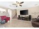 Open living space with a ceiling fan, tile floors, and a view of the staircase at 22959 W Cocopah St, Buckeye, AZ 85326