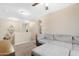 Comfortable loft area with plush carpeting and a sectional sofa, ideal for relaxing at 22959 W Cocopah St, Buckeye, AZ 85326