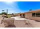 Private backyard featuring desert landscaping and a covered patio area at 26421 S New Town Dr, Sun Lakes, AZ 85248