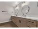 Bathroom features a double vanity with modern fixtures, framed mirrors and wood cabinets, offering both style and functionality at 26421 S New Town Dr, Sun Lakes, AZ 85248