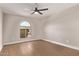 Spacious bedroom with an arched window and wooden floors at 26421 S New Town Dr, Sun Lakes, AZ 85248