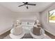 This bright bedroom features modern furniture, neutral paint, lots of natural light, and a ceiling fan at 26421 S New Town Dr, Sun Lakes, AZ 85248