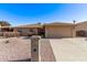 Ranch style home with desert landscaping, a two-car garage, and a well-manicured yard at 26421 S New Town Dr, Sun Lakes, AZ 85248