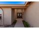 Close up of the front door with sidelights and decorative glass, with a concrete walkway at 26421 S New Town Dr, Sun Lakes, AZ 85248