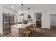 Stunning eat-in kitchen features a central island, modern appliances, custom cabinets, and a breakfast bar at 26421 S New Town Dr, Sun Lakes, AZ 85248