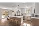 Bright, updated kitchen with a large center island, stainless steel appliances, and modern lighting at 26421 S New Town Dr, Sun Lakes, AZ 85248