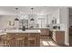 Gorgeous eat-in kitchen with modern cabinetry, stainless appliances, large central island, and stylish pendant lights at 26421 S New Town Dr, Sun Lakes, AZ 85248