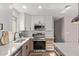 This modern kitchen features stainless steel appliances, marble countertops, a tiled backsplash, and a window view at 26421 S New Town Dr, Sun Lakes, AZ 85248
