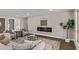 Cozy living room with a modern fireplace, stylish seating, and lots of natural light at 26421 S New Town Dr, Sun Lakes, AZ 85248