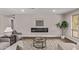 Inviting living room featuring a linear fireplace, contemporary decor, and hardwood floors at 26421 S New Town Dr, Sun Lakes, AZ 85248