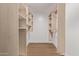 Spacious walk-in closet features built-in shelving and wooden floors at 26421 S New Town Dr, Sun Lakes, AZ 85248