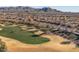 An aerial view showcases the golf course community nestled beneath majestic mountain views at 26880 W Sierra Pinta Dr, Buckeye, AZ 85396