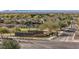 Aerial view of the Sun City Festival entrance sign and golf course amidst residential homes and landscape at 26880 W Sierra Pinta Dr, Buckeye, AZ 85396
