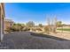 Paver patio overlooking desert landscaping, black metal fence and golf course view, perfect for relaxing outdoors at 26880 W Sierra Pinta Dr, Buckeye, AZ 85396