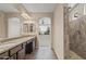 Bathroom featuring granite counters, dual sinks, dark cabinets, large walk in shower and tile floors at 26880 W Sierra Pinta Dr, Buckeye, AZ 85396
