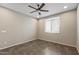 Neutral bedroom featuring tile floors, a ceiling fan and louvered window at 26880 W Sierra Pinta Dr, Buckeye, AZ 85396