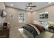 Comfortable bedroom with a ceiling fan, stylish decor, and a window, creating a relaxing atmosphere at 26880 W Sierra Pinta Dr, Buckeye, AZ 85396