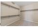 Walk in closet with carpet and white shelving on three sides at 26880 W Sierra Pinta Dr, Buckeye, AZ 85396